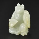 A WHITE AND RUSSET JADE ZODIAC FIGURE OF A RAT QING DYNASTY, QIANLONG PERIOD