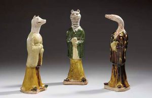 THREE RARE SANCAI-GLAZED AND PAINTED POTTERY ZODIAC FIGURES TANG DYNASTY (618-907)