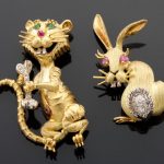 A pair of two diamond, gem-set and 18k gold animal brooches