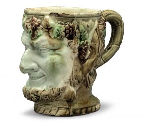 A STAFFORDSHIRE CREAMWARE SATYR-MASK MUG